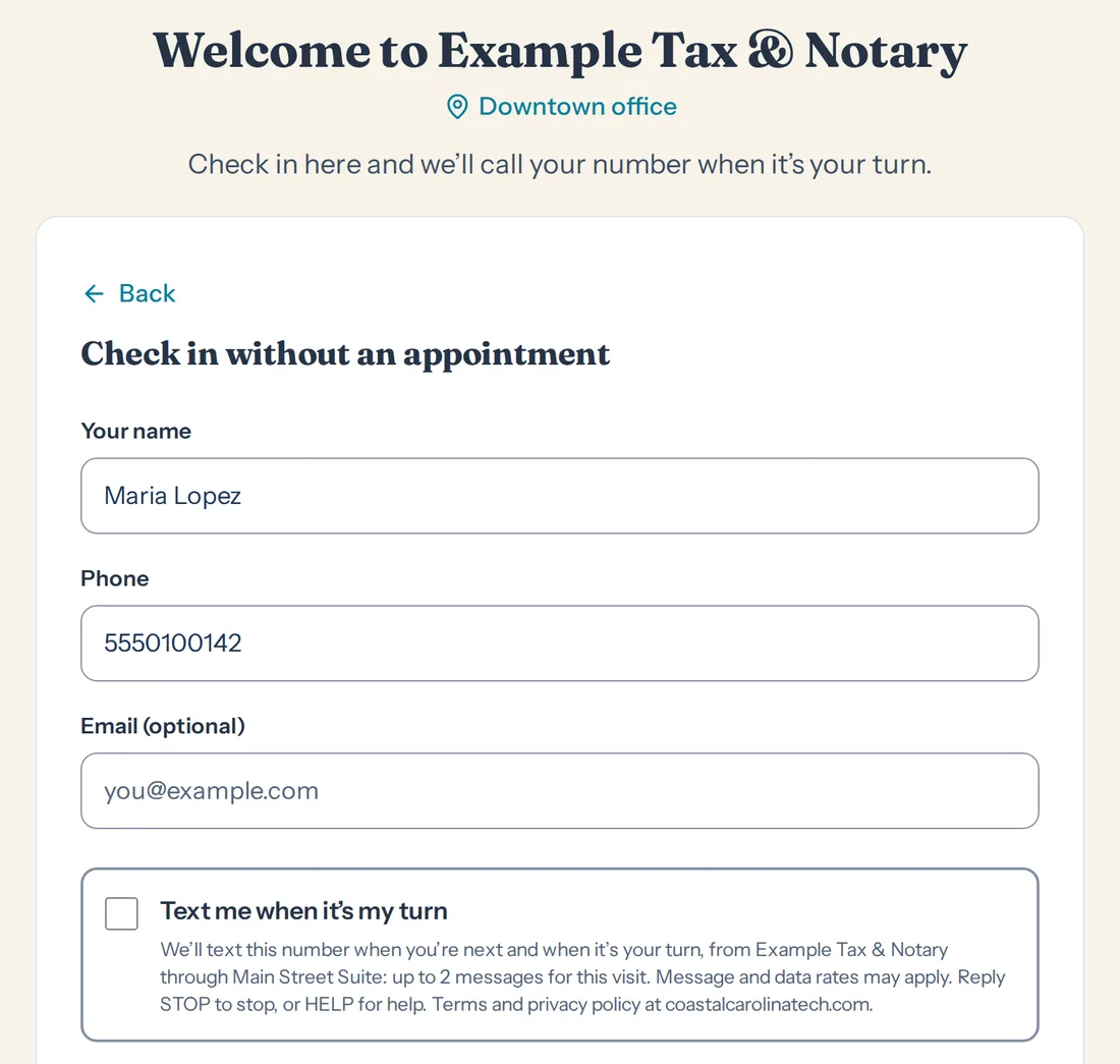 The lobby kiosk's check-in without an appointment: name, phone, email, and an unticked box reading Text me when it's my turn, with the wording under it.
